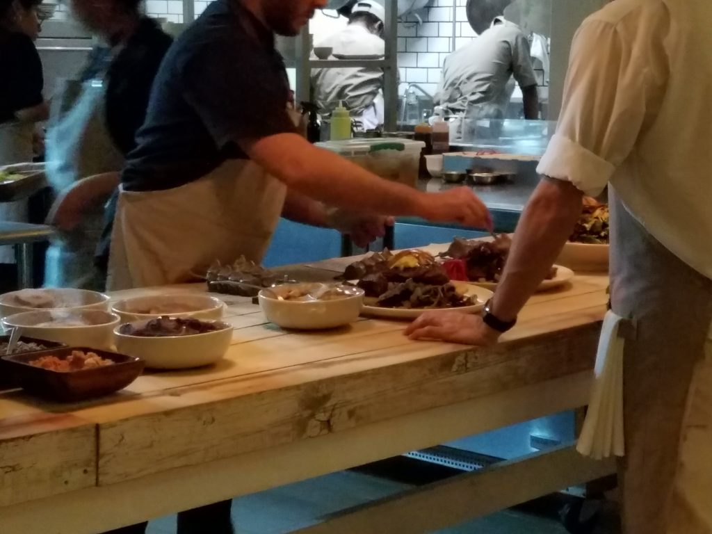 Chefs plating and applying finishing touches to each dish at Hueso Restaurant in Guadalara, Mexico Chefs plating and applying finishing touches to each dish at Hueso Restaurant in Guadalara, Mexico