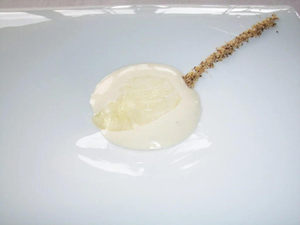 Lightly Smoked Cod cut transparent thin on a dollop of something with a creamy texture, with a powder trail of hazelnuts, coffee, and vanilla at Martin Berasategui