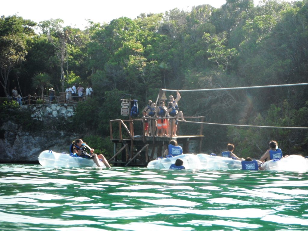 People floating and rope climbing Xel-Ha, Mexico