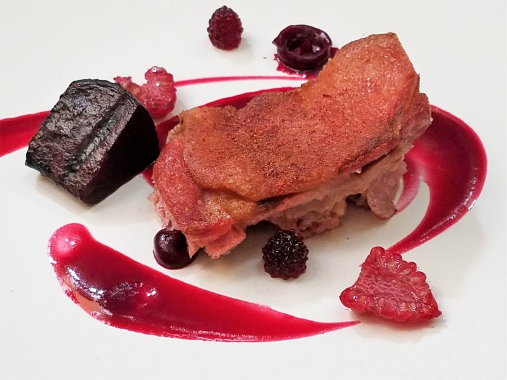 Duck Confit with beet sauce and raspberries at Aperi in San Miguel de Allende, Mexico