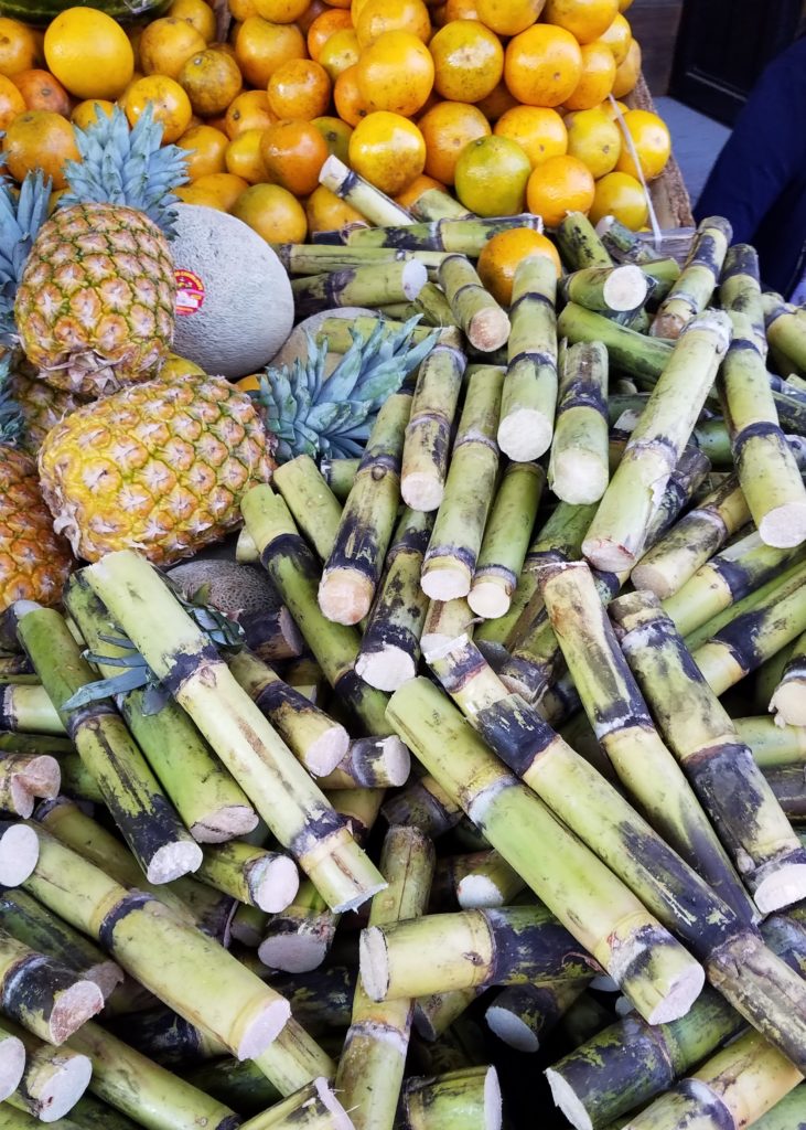 Sugarcane, pineapple and oranges at a small mercado