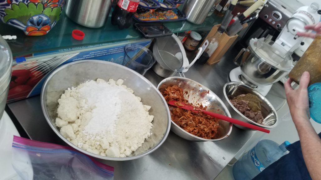 Bowls of masa, pork and tongue ready for tamales