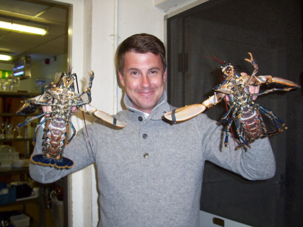 Tom holding our lobster dinners up at King Sitric, Howth, Ireland