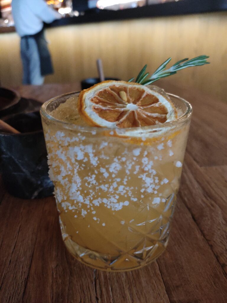 Pineapple Mezcalita with dehydrated orange and rosemary sprig